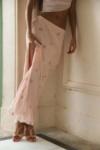 Detailed view of pink sequin beads and floral embroidery on a high slit maxi dress