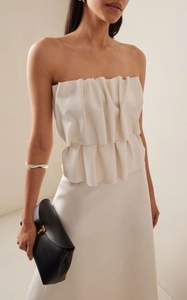 Detail shot of ivory strapless evening dress with double-layered pleated ruffles