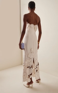 Detail of white strapless backless gown with 3D floral appliques and lace hollow design