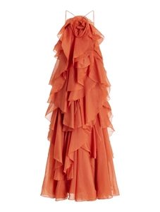 Detail of the orange halter maxi dress showing layered ruffles and 3D floral decoration