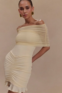 Detail of elegant cream off-shoulder dress featuring ruffled mesh and mermaid hem design