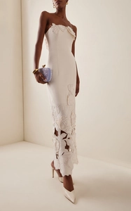 Detail of white tube maxi dress with 3D floral appliques and laser-cut hollow pattern