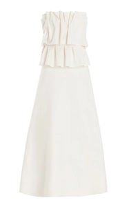 Detail view of the elegant ivory strapless dress showing layered pleated bodice texture