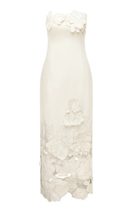 Close-up of 3D floral applique on a white strapless evening dress with hollow embroidery