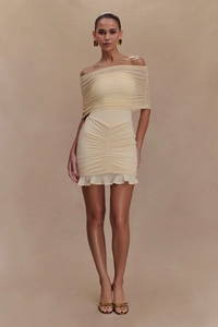Detail of cream off-the-shoulder mini dress with ruffled hem and shirred mesh texture