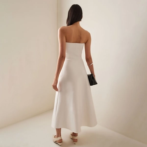 Elegant white strapless maxi dress with pleated details and a minimalist A-line silhouette