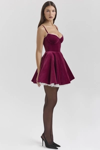 Detail view of burgundy velvet dress with white lace trim and puffy tulle lining
