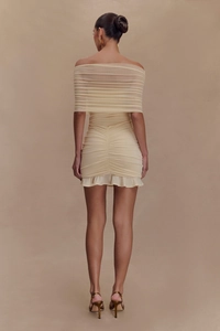Detail of elegant off-shoulder ruffles and layered ruching on a beige slim bodycon dress
