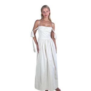Elegant white satin maxi dress with off-the-shoulder straps and ribbon details