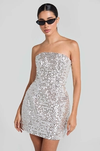 Close-up of sparkling silver sequins on a strapless mini dress with reflective texture