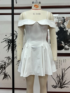 Detail of white off-shoulder mini dress with pleated skirt and thin straps on a mannequin