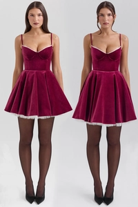 Detail of burgundy velvet mini dress showing lace trim and fitted corset bodice