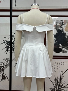 Detail view of the white off-shoulder mini dress back with invisible zipper closure