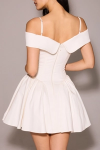 Detailed back view of white off-shoulder mini dress with invisible zipper and pleated skirt