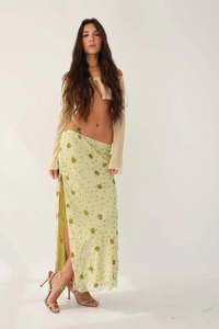 Detail of sequin floral pattern on long side-slit skirt with sheer long-sleeve crop top