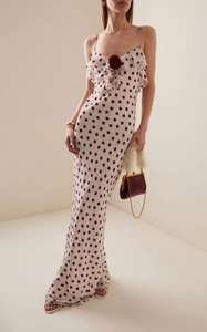 Detailed view of the 3D rose accent and ruffle neckline on the polka dot maxi dress