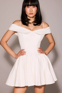 Detail of white off-shoulder satin dress with thin straps and tailored waist design