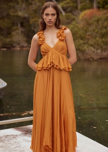 Detail of ochre yellow chiffon maxi dress showing ruffle straps and deep V-neckline