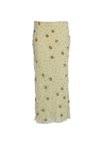 Detailed close-up of intricate green beadwork and sequins on light yellow dress fabric