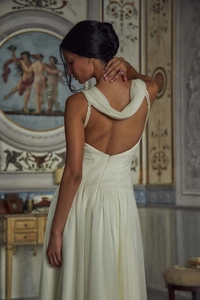 Elegant off-white backless evening dress featuring a sophisticated cowl neck drape detail