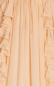 Detail of elegant pleated apricot chiffon fabric with ruffles and long neck ties