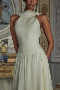 Detail of the pleated halter neckline on a sophisticated cream-white chiffon evening gown