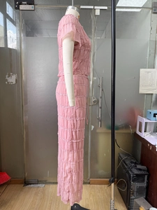 Detail view of the pink pleated chiffon fabric on a two-piece fashion set for women