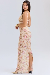 Detail of slim-fit floral maxi dress featuring a high back slit and apricot mesh fabric