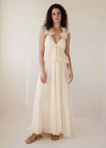 Detailed view of deep V-neckline with ruffled lace accents on a flowing cream maxi dress
