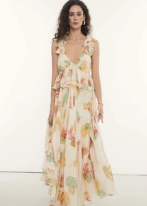Detailed view of deep V-neck ruffle shoulder straps and marine print on long summer dress