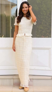 Detail of cream beige pleated chiffon two-piece set with ruffled edges and high waist skirt
