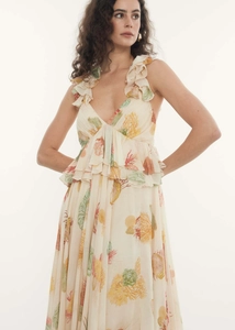 Detail view of the deep V-neckline and colorful coral print on the ruffled floral dress