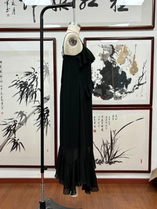 Detail view of the layered ruffles on the elegant black chiffon V-neck maxi dress