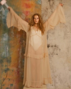 Detailed view of bohemian sheer beach dress featuring ruffle tiers and tie neckline