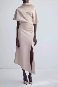 Detail view of a pale pink asymmetric dress featuring elegant waist pleats and side slit