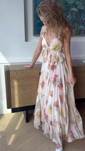 Detail view of deep V-neckline with ruffled trim on a bohemian floral maxi dress