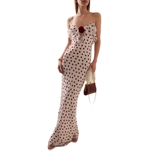 Polka dot white satin maxi dress with spaghetti straps and a red floral accent