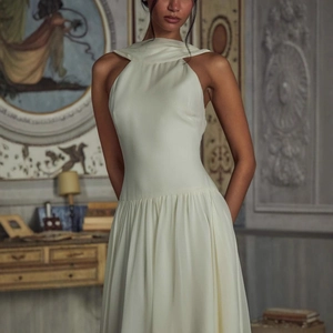 Elegant white halter neck pleated evening dress with refined draping and silky texture