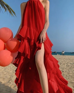 Detail of red halter beach dress featuring layered ruffles and a side high-slit design