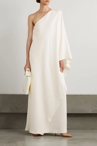 Detail showing the elegant ivory satin fabric and draped one-shoulder design of the gown