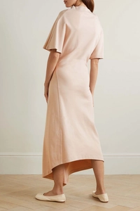 Detail of light peach midi dress with irregular hem and high round neckline