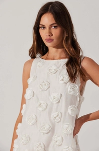 Detail of white sleeveless dress showing intricate 3D handmade rose flower texture