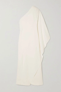 Detail of elegant one-shoulder cream satin gown with flowing cape sleeve and asymmetric cut