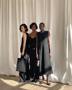 Three elegant black minimalist outfits featuring tiered long dresses and wide-leg trousers
