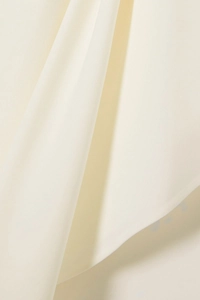Macro shot of elegant cream satin fabric with smooth texture and luxury drape details