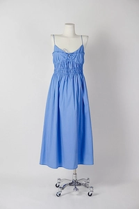 Detail of sky blue backless midi dress featuring ruffled neckline and bow tie design