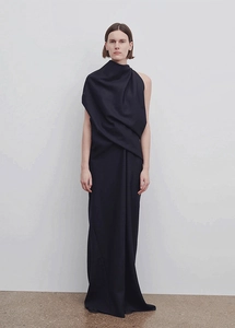 Detail of elegant dark navy maxi dress showing draped fabric texture and shoulder design