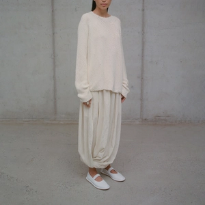 Minimalist cream knit sweater and lantern pants ensemble with white Mary Jane shoes