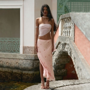 Pink sequin two-piece set featuring a halter top and high slit maxi skirt for vacation