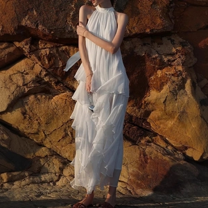 White halter neck tiered ruffle maxi beach dress in flowing tencel fabric for summer